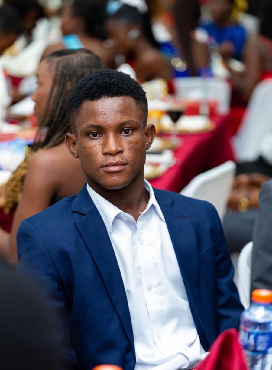 Amadu Kamal in a navy suit at an evening event